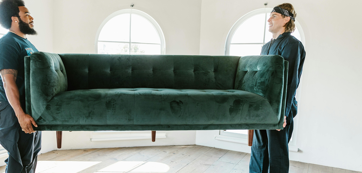 Professional movers carrying sofa